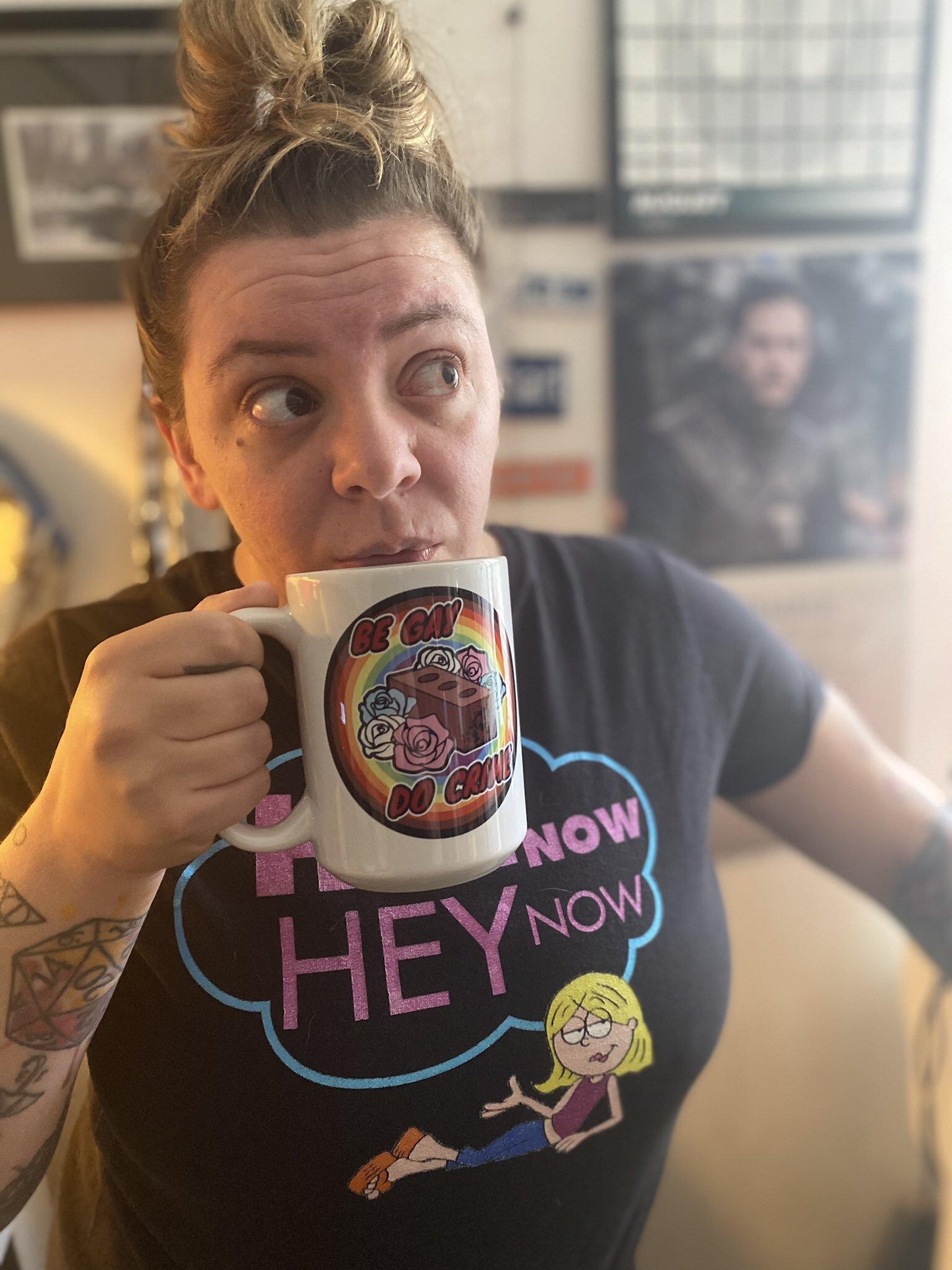 Novi Studios producer Nicole Montello shows off the “Be Gay Do Crime” mug available at Crime.gay